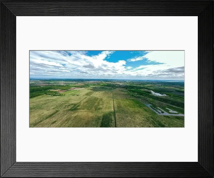 Framed Print : A very wide aerial view of farmland and rural wisconsin in spring under a cloudy blue sky Framed Print : A very wide aerial view of farmland and rural wisconsin in spring under a cloudy blue sky