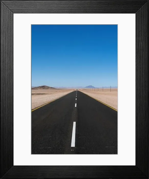 Framed Print : A kilometer long paved straight road in the desert of Namibia Framed Print : A kilometer long paved straight road in the desert of Namibia