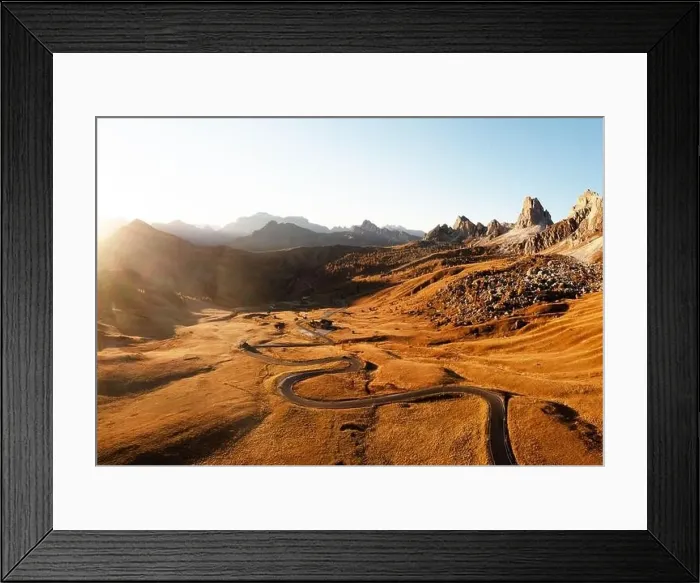 Framed Print : Picturesque aerial view on winding road in autumn mountain valley at sunset Framed Print : Picturesque aerial view on winding road in autumn mountain valley at sunset