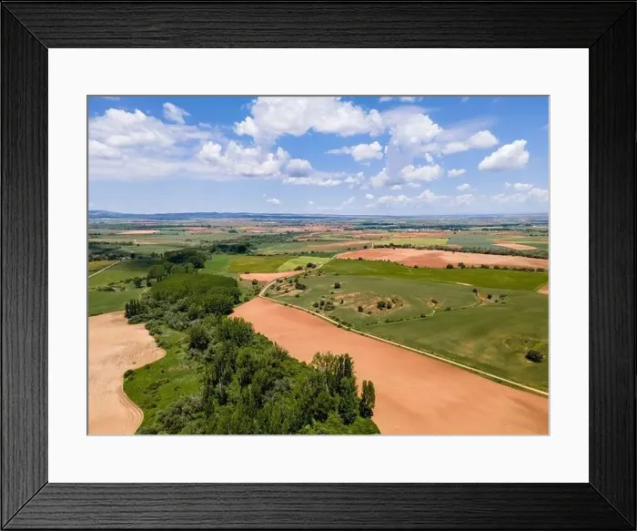 Framed Print : Aerial view of fields of Castile with agricultural plots and blue sky with clouds. Castilla
