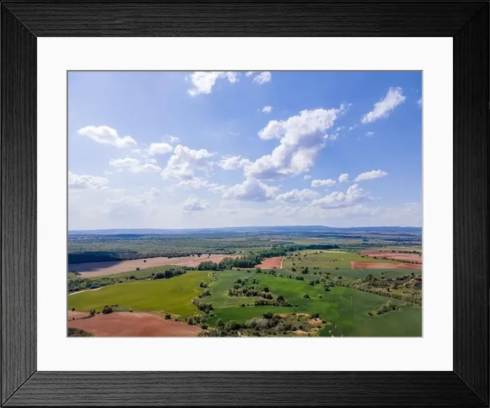Framed Print : Aerial view of fields of Castile with agricultural plots and blue sky with clouds. Castile Spain Framed Print : Aerial view of fields of Castile with agricultural plots and blue sky with clouds. Castile Spain