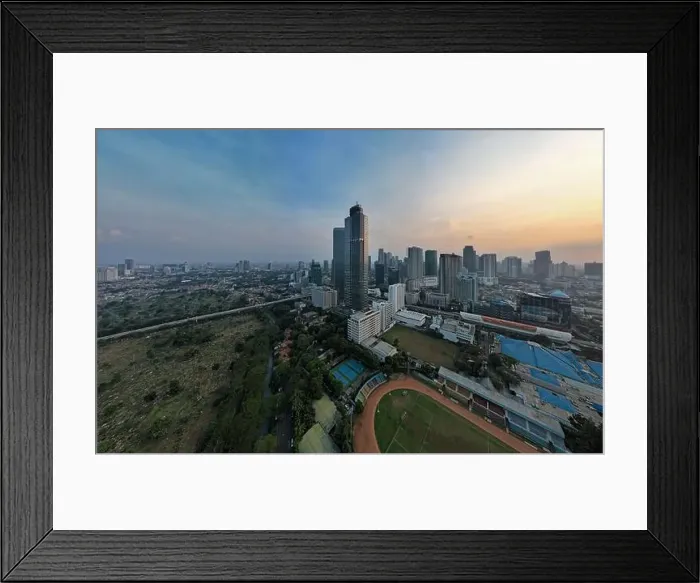 Framed Print : Aerial view of office buildings in Jakarta central business district and noise cloud when sunset Framed Print : Aerial view of office buildings in Jakarta central business district and noise cloud when sunset
