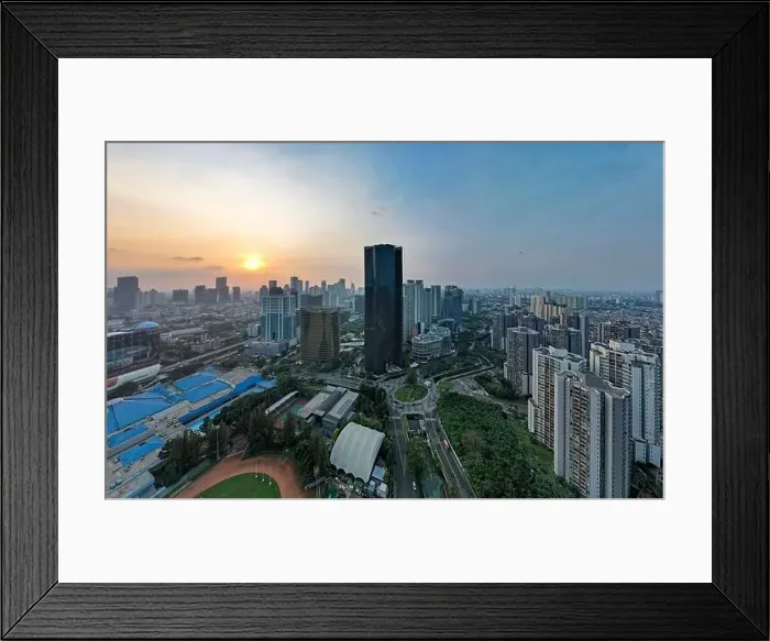 Framed Print : Aerial view of office buildings in Jakarta central business district and noise cloud when sunset Framed Print : Aerial view of office buildings in Jakarta central business district and noise cloud when sunset