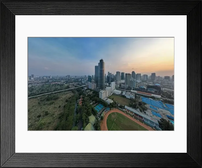 Framed Print : Aerial view of office buildings in Jakarta central business district and noise cloud when sunset Framed Print : Aerial view of office buildings in Jakarta central business district and noise cloud when sunset