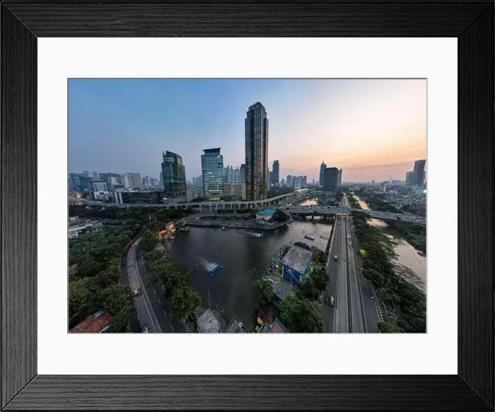 Framed Print : Aerial view of office buildings in Jakarta central business district and noise cloud when sunset Framed Print : Aerial view of office buildings in Jakarta central business district and noise cloud when sunset