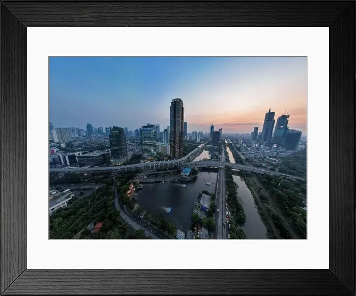 Framed Print : Aerial view of office buildings in Jakarta central business district and noise cloud when sunset Framed Print : Aerial view of office buildings in Jakarta central business district and noise cloud when sunset