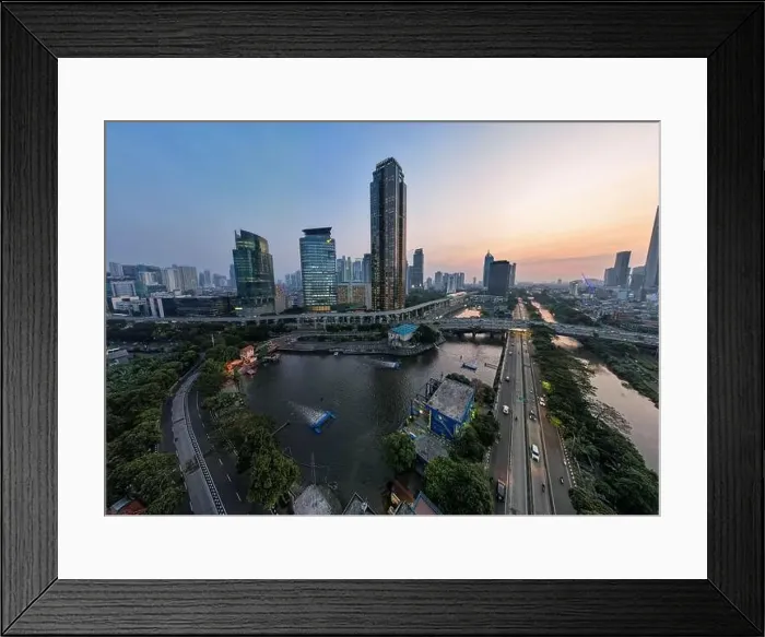 Framed Print : Aerial view of office buildings in Jakarta central business district and noise cloud when sunset Framed Print : Aerial view of office buildings in Jakarta central business district and noise cloud when sunset