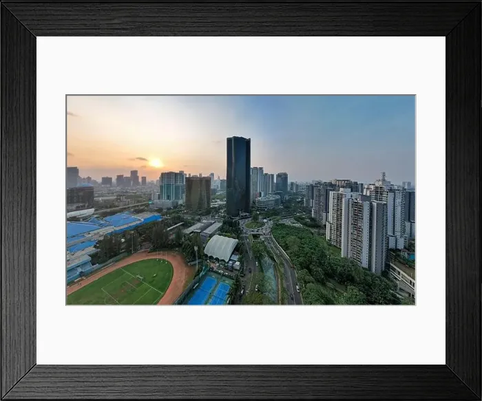 Framed Print : Aerial view of office buildings in Jakarta central business district and noise cloud when sunset Framed Print : Aerial view of office buildings in Jakarta central business district and noise cloud when sunset