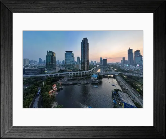 Framed Print : Aerial view of office buildings in Jakarta central business district and noise cloud when sunset Framed Print : Aerial view of office buildings in Jakarta central business district and noise cloud when sunset