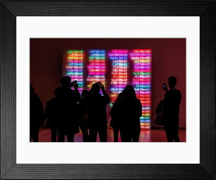 Framed Print : A back view of people taking photos of illuminated neon signs at a museum in New York Framed Print : A back view of people taking photos of illuminated neon signs at a museum in New York