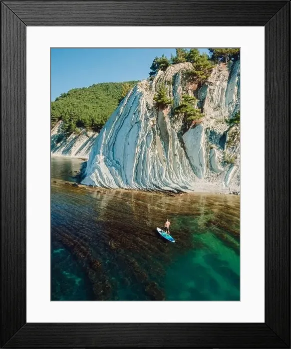 Framed Print : Man traveling on stand up paddle board in sea Framed Print : Man traveling on stand up paddle board in sea