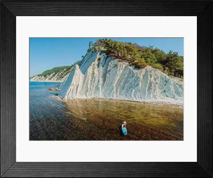 Framed Print : Man traveling on stand up paddle board in sea Framed Print : Man traveling on stand up paddle board in sea