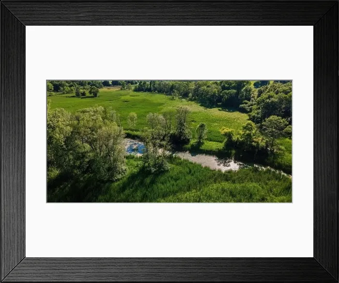 Framed Print : A stream runs through the wilderness surrounded by natural woodland and meadows Framed Print : A stream runs through the wilderness surrounded by natural woodland and meadows