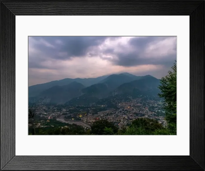 Framed Print : Cityscape of mountain city with cloudy sky and zigzag river Framed Print : Cityscape of mountain city with cloudy sky and zigzag river