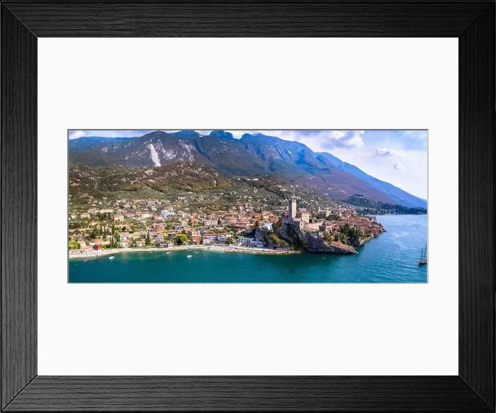 Framed Print : Amazing italian lake scenery - beautiful Lago di Garda. Aerial view of Malcesine castle, vilage and beach