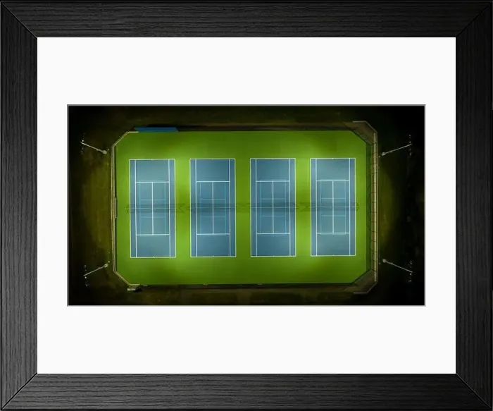 Framed Print : Evening aerial video of outdoor blue tennis courts with pickleball lines with lights turned on Framed Print : Evening aerial video of outdoor blue tennis courts with pickleball lines with lights turned on