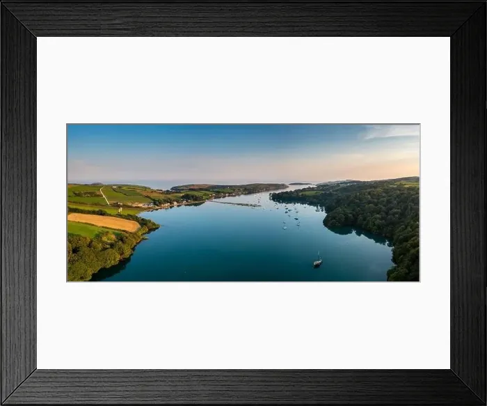 Framed Print : An aerial panorama landscape in warm evening light over Castlehaven Bay with many sailboats anchored Framed Print : An aerial panorama landscape in warm evening light over Castlehaven Bay with many sailboats anchored