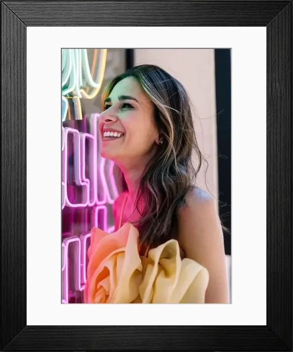 Framed Print : Cheerful young woman by illuminated neon lights Framed Print : Cheerful young woman by illuminated neon lights