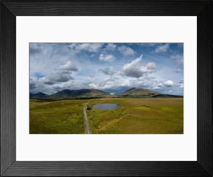 Framed Print : narrow country road leads into the wild landscape of the Connemara National Park in western Ireland