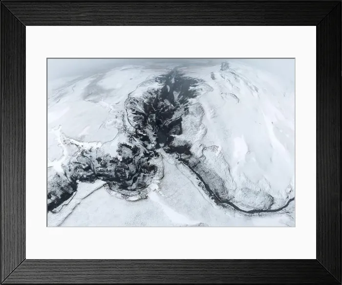 Framed Print : Aerial top view of fast streams flowing on uneven rocky terrain covered with snow on cold winter day in Iceland Framed Print : Aerial top view of fast streams flowing on uneven rocky terrain covered with snow on cold winter day in Iceland
