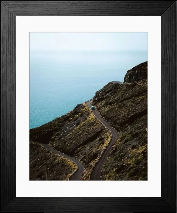 Framed Print : Breathtaking view of vehicle driving on curvy road on slope of mountain against sea during trip in La Palma, Spain Framed Print : Breathtaking view of vehicle driving on curvy road on slope of mountain against sea during trip in La Palma, Spain