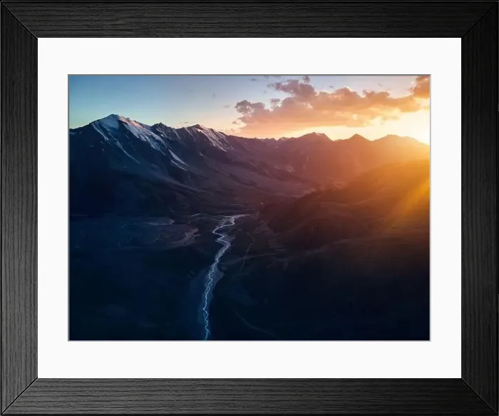 Framed Print : Beautiful scenery of the mountains with snow glacier and river in silhouette at orange sunset sky Almaty Framed Print : Beautiful scenery of the mountains with snow glacier and river in silhouette at orange sunset sky Almaty