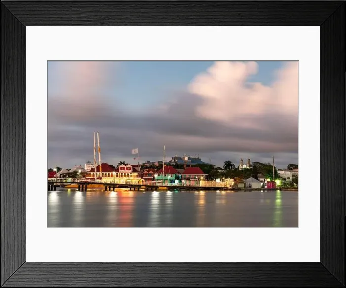 Framed Print : Colorful buildings of Heritage Quay shopping district reflected in the sea at dusk Framed Print : Colorful buildings of Heritage Quay shopping district reflected in the sea at dusk