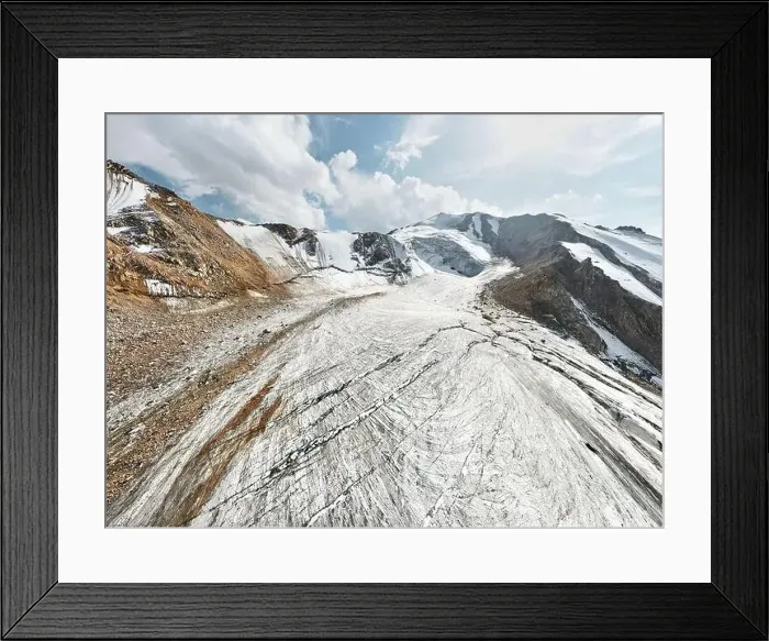 Framed Print : Beautiful scenery of the ice glacier with crack and snow cap of mountains near Almaty city Framed Print : Beautiful scenery of the ice glacier with crack and snow cap of mountains near Almaty city