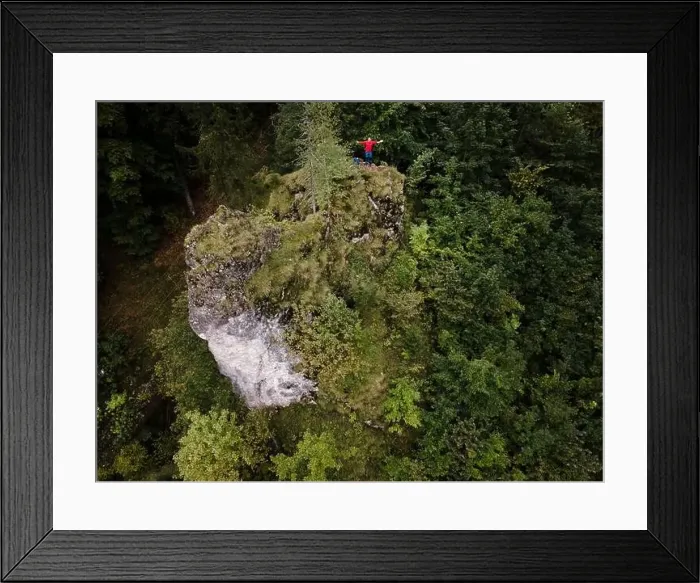Framed Print : Hiker, middle-aged climber is on rock Framed Print : Hiker, middle-aged climber is on rock