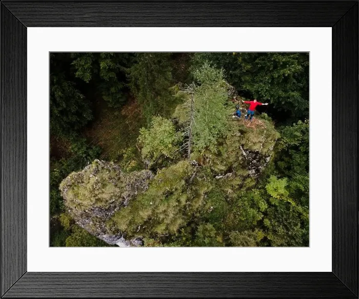 Framed Print : Hiker, middle-aged climber is on rock Framed Print : Hiker, middle-aged climber is on rock