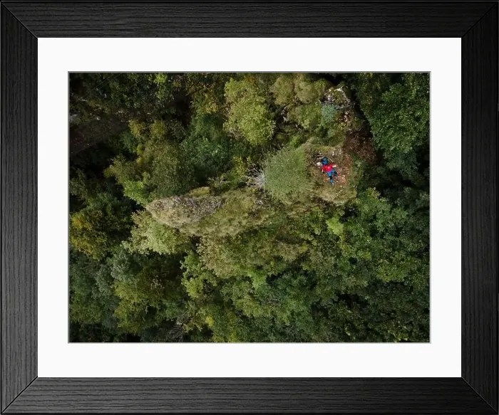 Framed Print : Hiker, middle-aged climber is on rock Framed Print : Hiker, middle-aged climber is on rock
