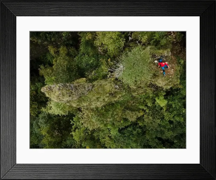 Framed Print : Hiker, middle-aged climber is on rock Framed Print : Hiker, middle-aged climber is on rock