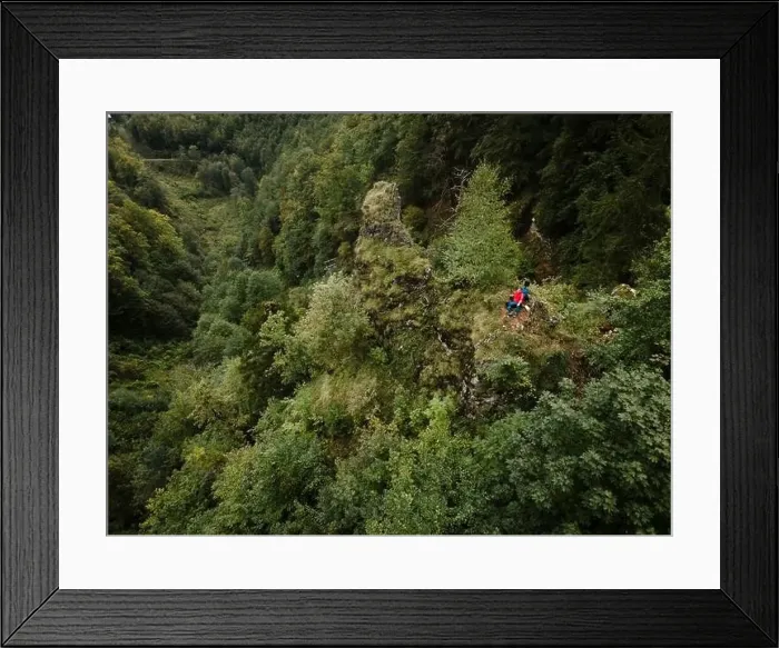Framed Print : Hiker, middle-aged climber is on rock Framed Print : Hiker, middle-aged climber is on rock