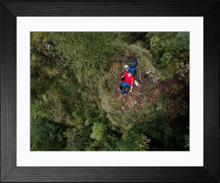 Framed Print : Hiker, middle-aged climber is on rock Framed Print : Hiker, middle-aged climber is on rock