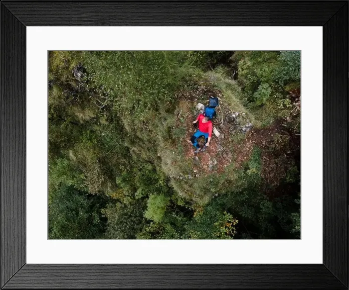Framed Print : Hiker, middle-aged climber is on rock Framed Print : Hiker, middle-aged climber is on rock