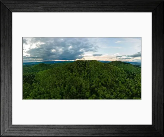Framed Print : Aerial wide panoramic view of dark mountain hills covered with green mixed pine and lush forest in evening Framed Print : Aerial wide panoramic view of dark mountain hills covered with green mixed pine and lush forest in evening
