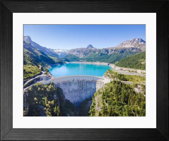 Framed Print : Water dam and reservoir lake aerial view in Alps mountains in summer generating hydroelectricity Framed Print : Water dam and reservoir lake aerial view in Alps mountains in summer generating hydroelectricity