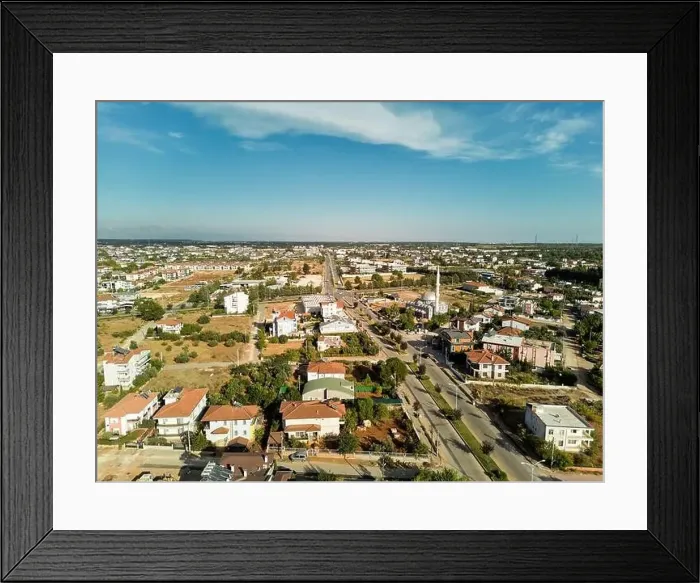 Framed Print : Aerial photograph of a town at sunset. A town with two-storey detached houses and a mosque Framed Print : Aerial photograph of a town at sunset. A town with two-storey detached houses and a mosque