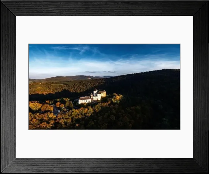 Framed Print : Lockenhaus, Austria - 7 October, 2022: panorama of Lockenhaus Castle surrounded by autumn forest in warm evening light Framed Print : Lockenhaus, Austria - 7 October, 2022: panorama of Lockenhaus Castle surrounded by autumn forest in warm evening light