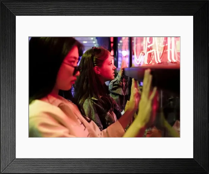 Framed Print : Lesbian couple touching wall with illuminated neon lights Framed Print : Lesbian couple touching wall with illuminated neon lights
