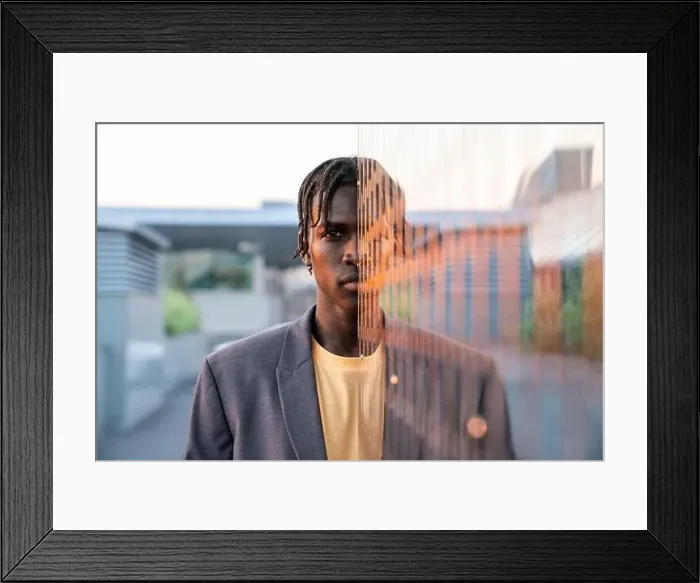 Framed Print : Young businessman in front of metal wall