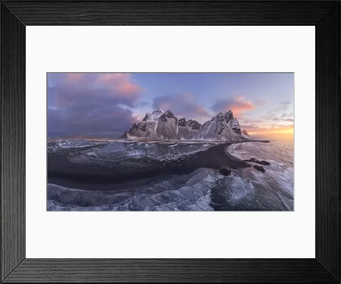Framed Print : Drone view of calm frozen endless sea surrounding high rocky snowy Vestrahorn mountain during picturesque sunset in Framed Print : Drone view of calm frozen endless sea surrounding high rocky snowy Vestrahorn mountain during picturesque sunset in