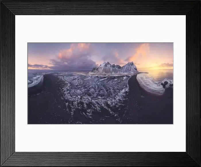 Framed Print : Drone view of calm frozen endless sea surrounding high rocky snowy Vestrahorn mountain during picturesque sunset in Framed Print : Drone view of calm frozen endless sea surrounding high rocky snowy Vestrahorn mountain during picturesque sunset in