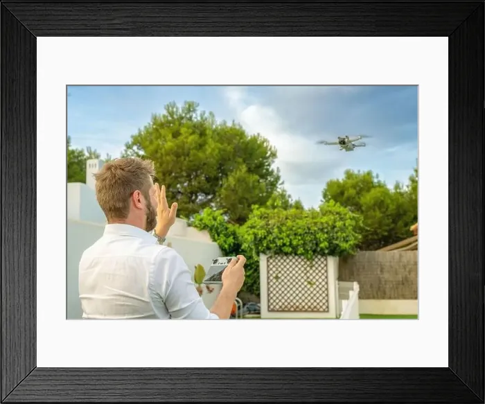 Framed Print : Young man launches a drone into the sky Framed Print : Young man launches a drone into the sky