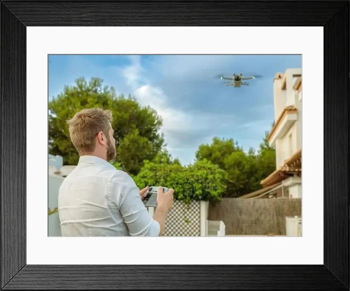 Framed Print : Young man launches a drone into the sky Framed Print : Young man launches a drone into the sky