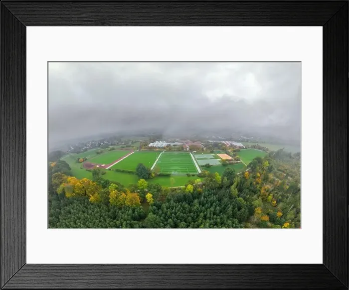 Framed Print : Aerial of a soccer pitch in the fall season with a lot of fog and a forest in the foreground Framed Print : Aerial of a soccer pitch in the fall season with a lot of fog and a forest in the foreground