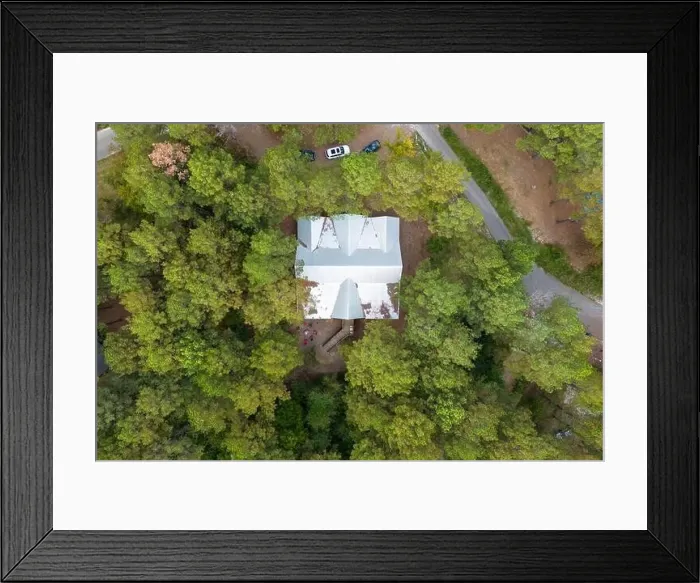 Framed Print : Aerial view of secluded cottage in the woods among green trees Framed Print : Aerial view of secluded cottage in the woods among green trees