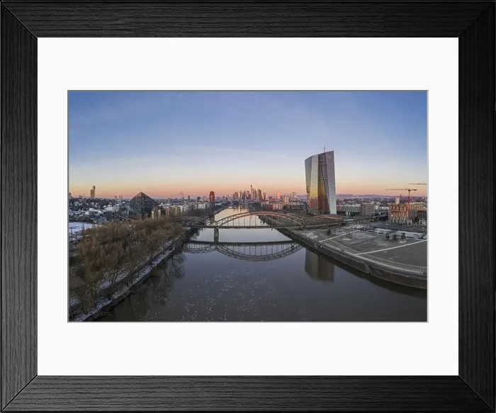 Framed Print : Aerial panoramic picture of Deutschherrnbrücke with Frankfurt skyline during sunrise in winter Framed Print : Aerial panoramic picture of Deutschherrnbrücke with Frankfurt skyline during sunrise in winter