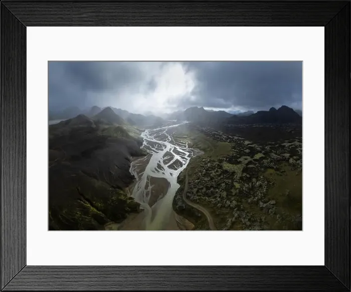 Framed Print : Breathtaking drone view of river estuary in sunlit valley amidst mountains in cloudy morning in Iceland Framed Print : Breathtaking drone view of river estuary in sunlit valley amidst mountains in cloudy morning in Iceland