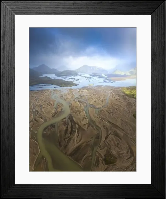 Framed Print : Breathtaking drone view of river estuary in sunlit valley amidst mountains in cloudy morning in Iceland Framed Print : Breathtaking drone view of river estuary in sunlit valley amidst mountains in cloudy morning in Iceland